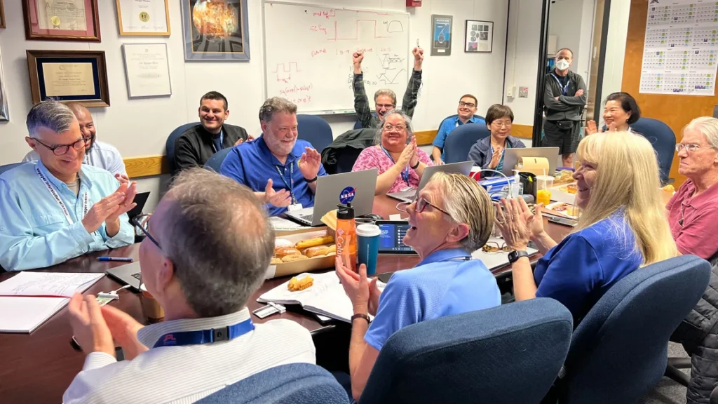 Members of the Voyager flight team celebrate after receiving the first coherent data from Voyager 1 in five months at NASA's Jet Propulsion Laboratory on April 20. 