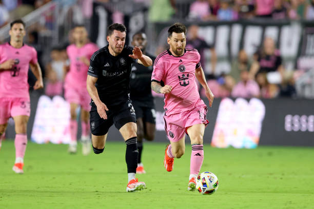 APRIL 20: Daniel Lovitz of Nashville SC and Lionel Messi of Inter Miami chase after the ball during the first half.