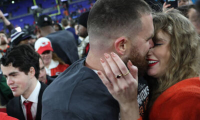 Travis Kelce #87 of the Kansas City Chiefs embraces Taylor Swift