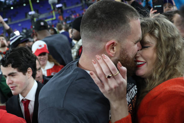 Travis Kelce  of the Kansas City Chiefs embraces Taylor Swift