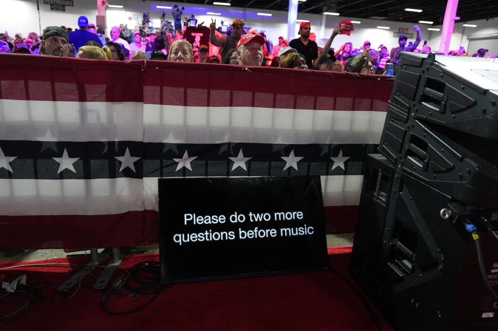 A teleprompter asks Trump to take two more questions from the crowd before pivoting to music. (Jabin Botsford/The Washington Post)