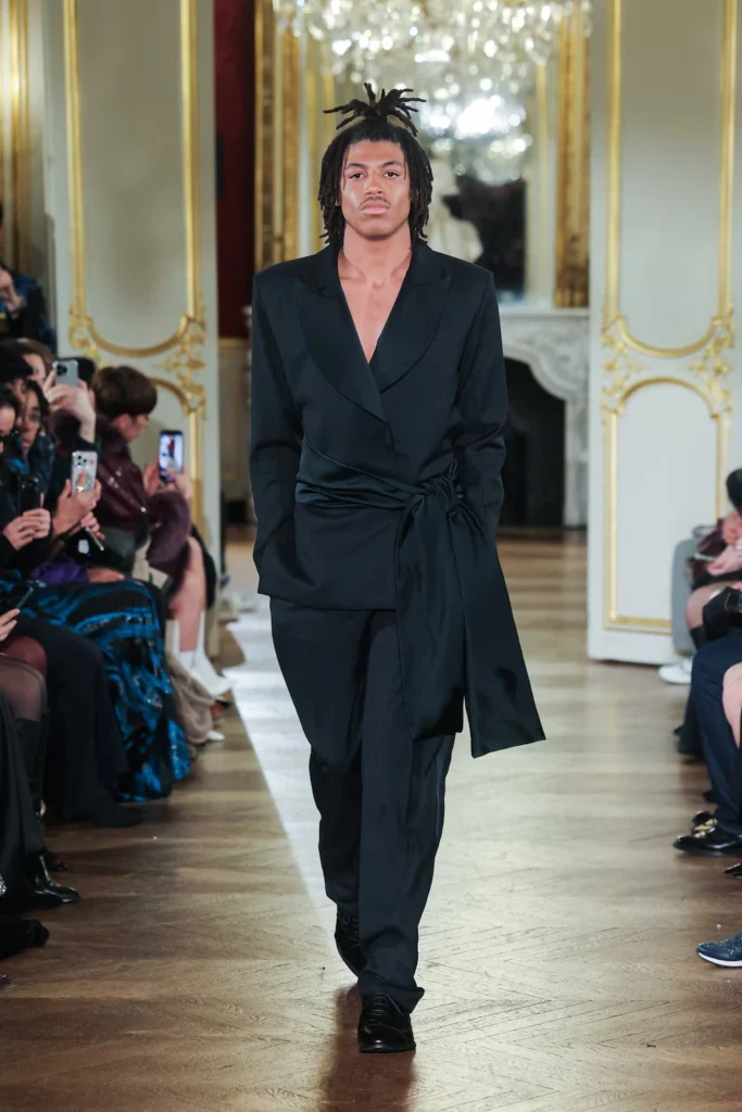 Henry Samuel, Heidi Klum’s son, makes his runway debut at Paris Haute Couture Fashion Week, opening the Lena Erziak show in a sleek black pantsuit.